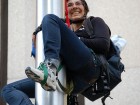 Eriel Tchekwie Deranger climbs the flagpole in front of RBC on July 28, 2009. Photos courtesy Rainforest Action Network.