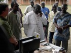 In 2007, Ugandan Archbishop Odama places an internet phone call to an internally-displaced people's camp 70 km away. Internet technologies are encouraging ground-up development like this across the continent. Photo courtesy Bosco-Uganda.