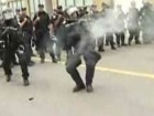riot police shooting tear gas canister