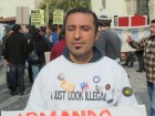 Protester Rey Ramirez holds a sign at the Occupy ICE rally in Los Angeles. Thursday, December 15, 2011.