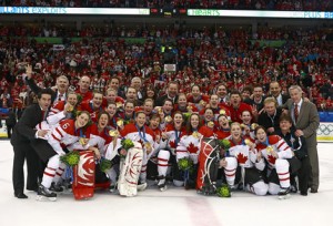 Canada's women's Olympic hockey team pose with their gold medals after the winning game.