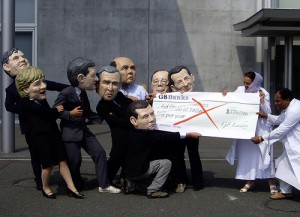 Costumed activists pretend to revoke aid cheque