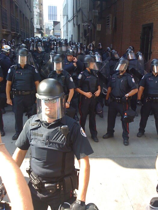 Riot police in alleyway on College Street.