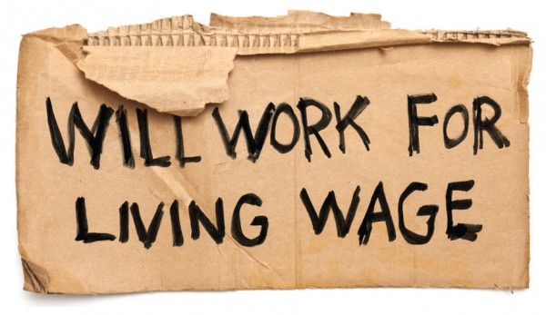 cardboard sign reading Will Work for Living Wage