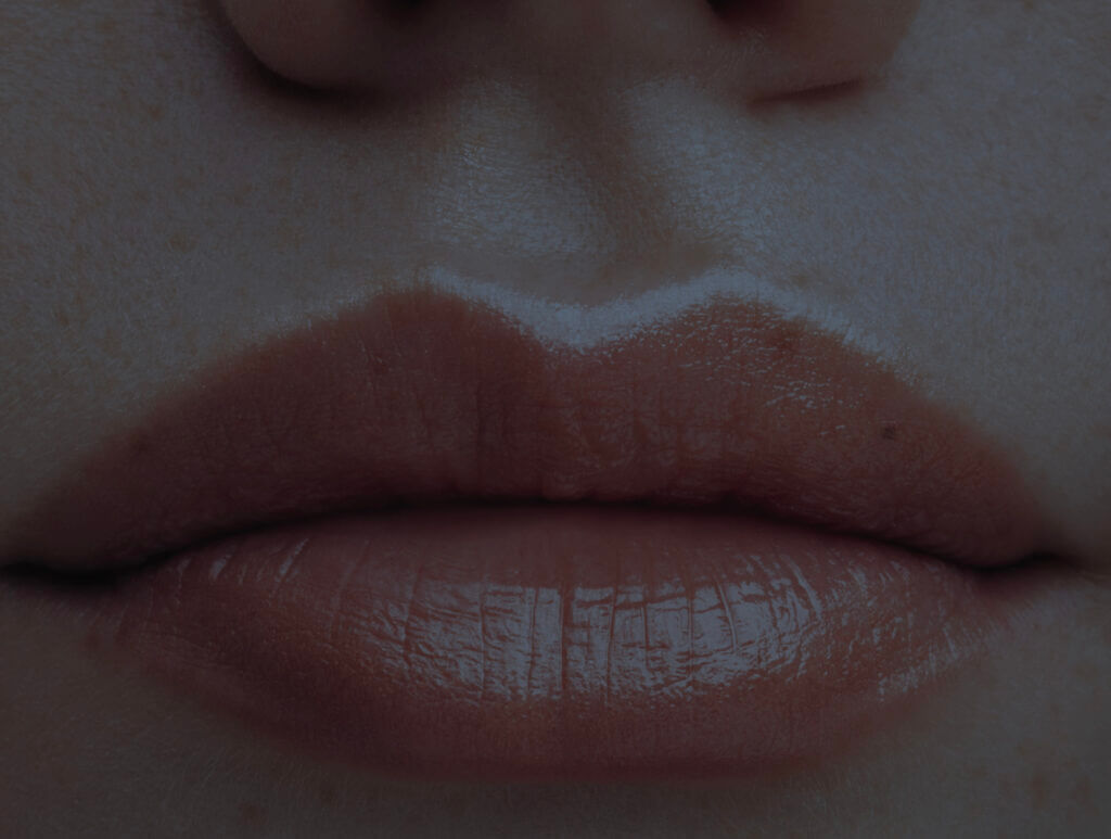 An extreme close up of someone's closed lips