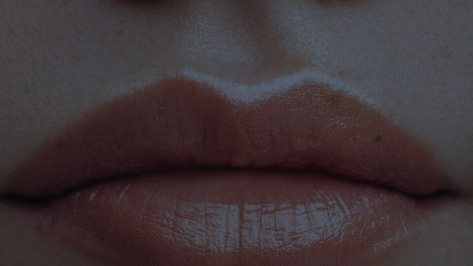An extreme close up of someone's closed lips