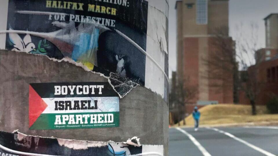 A sticker on a Halifax lamppost reads "Boycott Israeli Apartheid" over a Palestinian flag