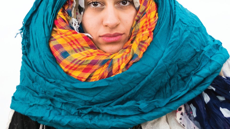 Photo of a woman wearing multiple, bulky headscarves.