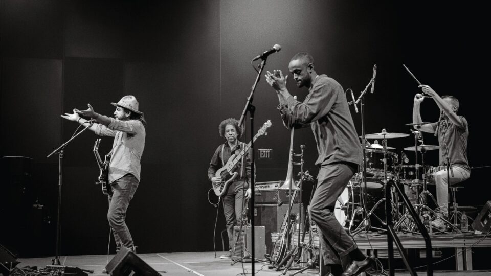 Black and white photo of a band playing on a stage.