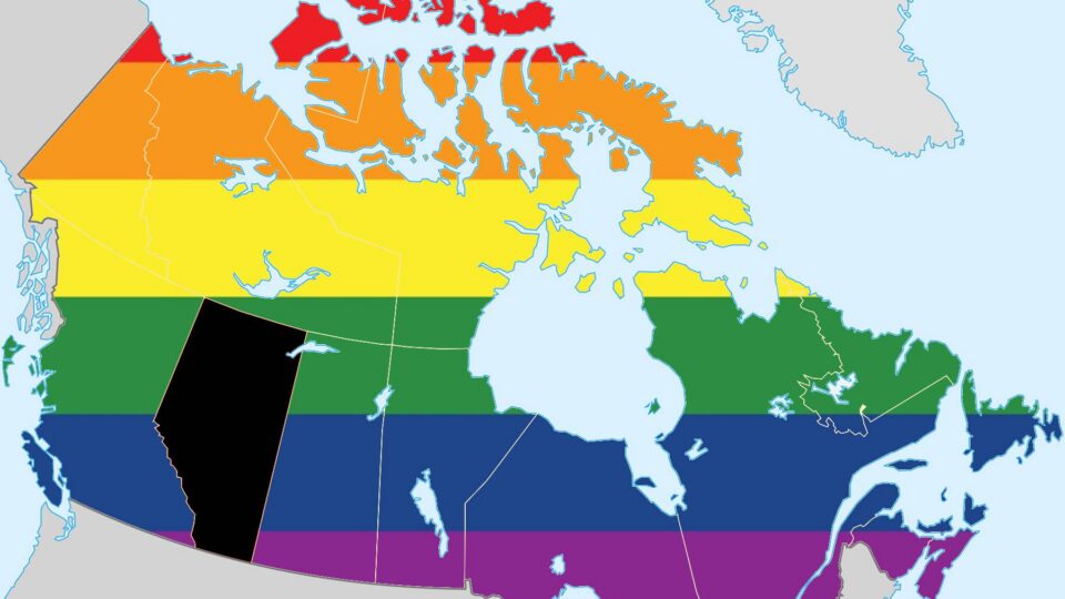 Image of a map of Canada with the provinces coloured in with the pride flag rainbow. Alberta is left black.